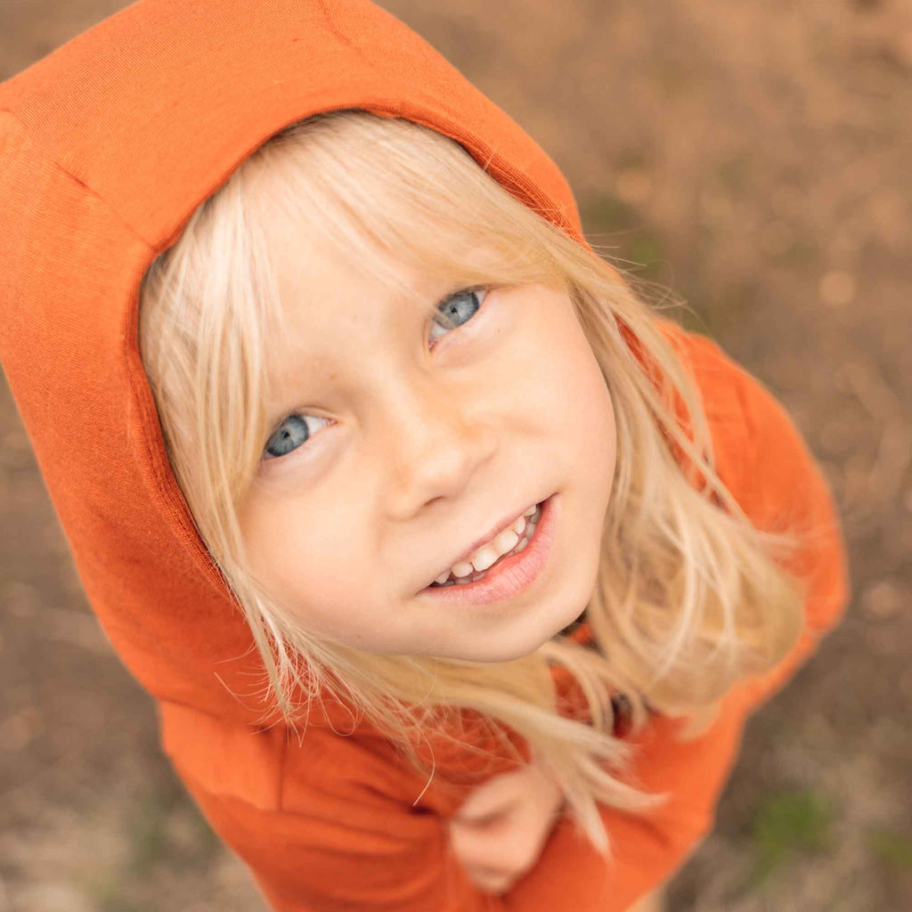 UPF 50+ sun hoodie outdoors, offering sun protection and comfort.