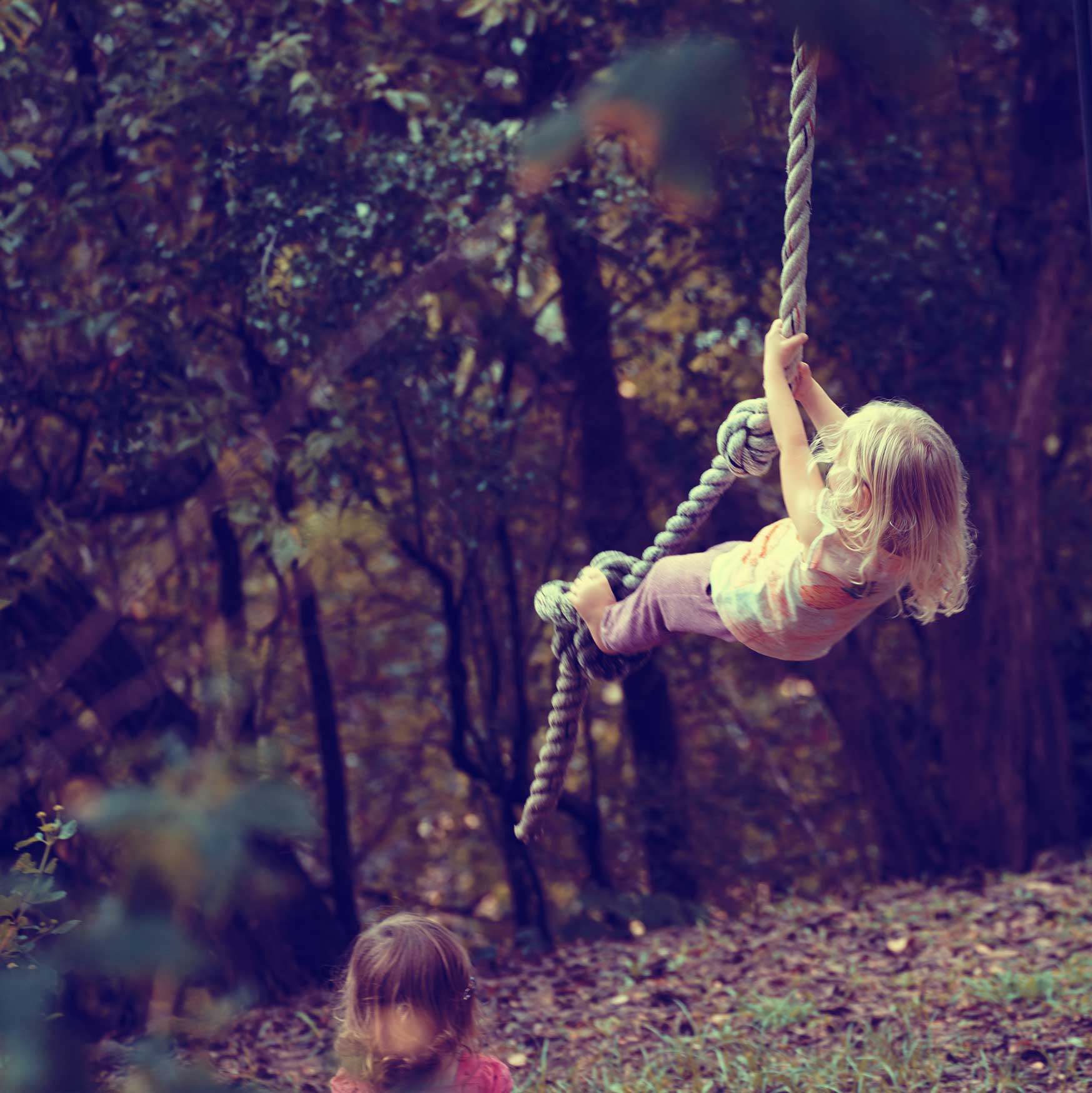 Milk x Whiskey - A little girl swinging on a rope swing in the outdoors while adventuring in the forrest.
